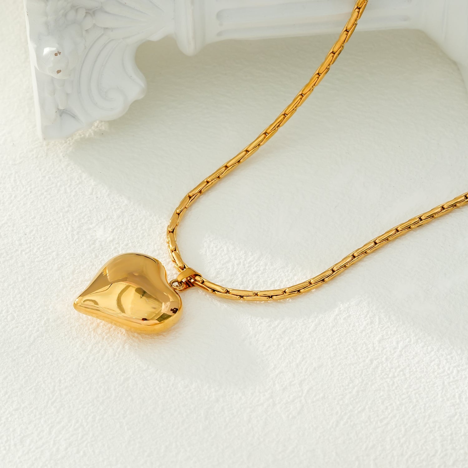 ABEL: Engineered Cable Chain with Puffy Heart Pendant in Gold.