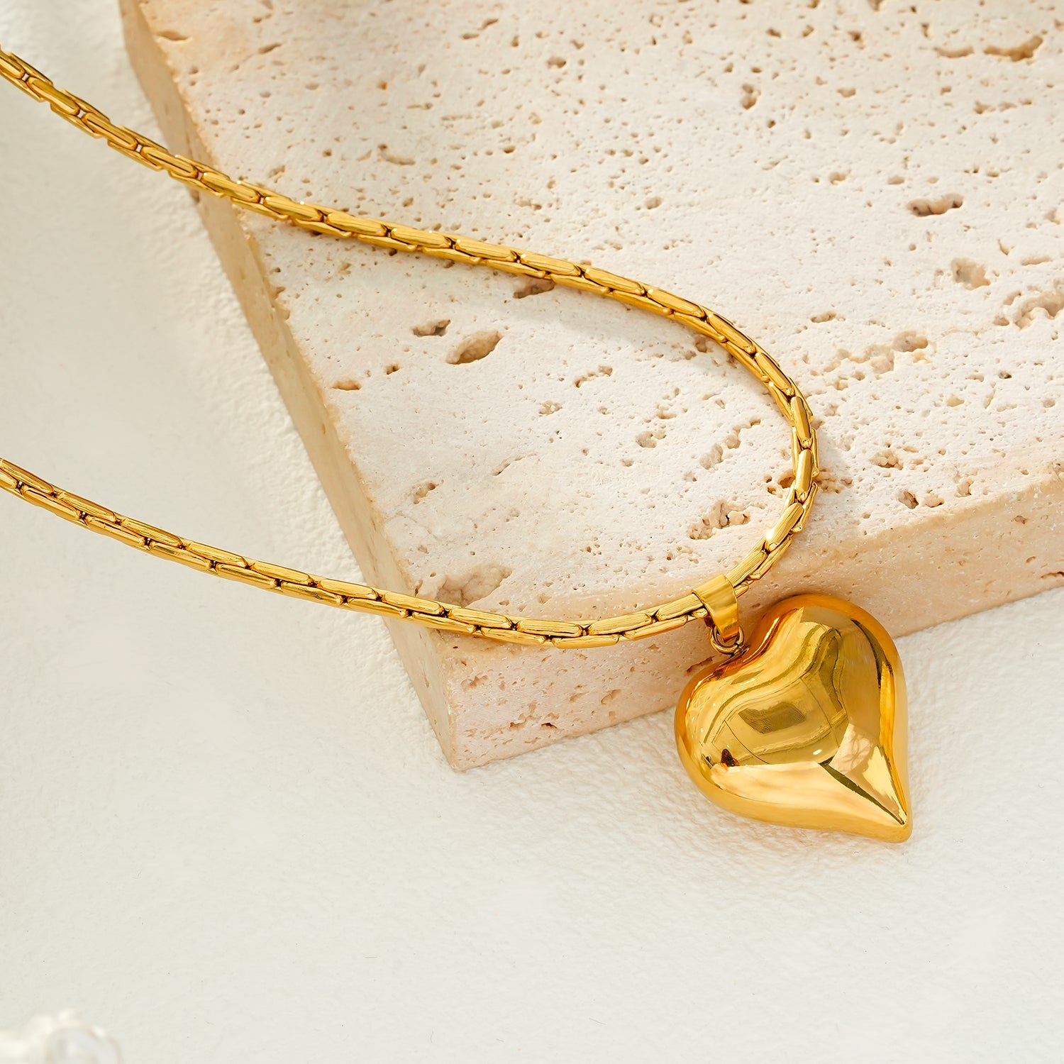 ABEL: Engineered Cable Chain with Puffy Heart Pendant in Gold.