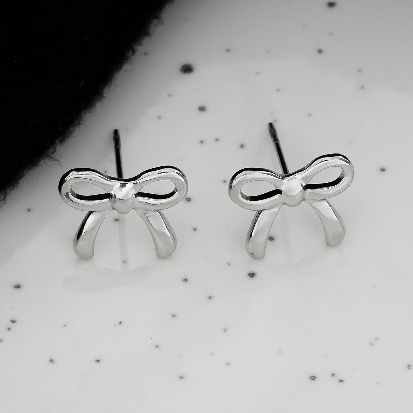 BOW: Silver Toned White Gold Bow Shaped Stud Earrings