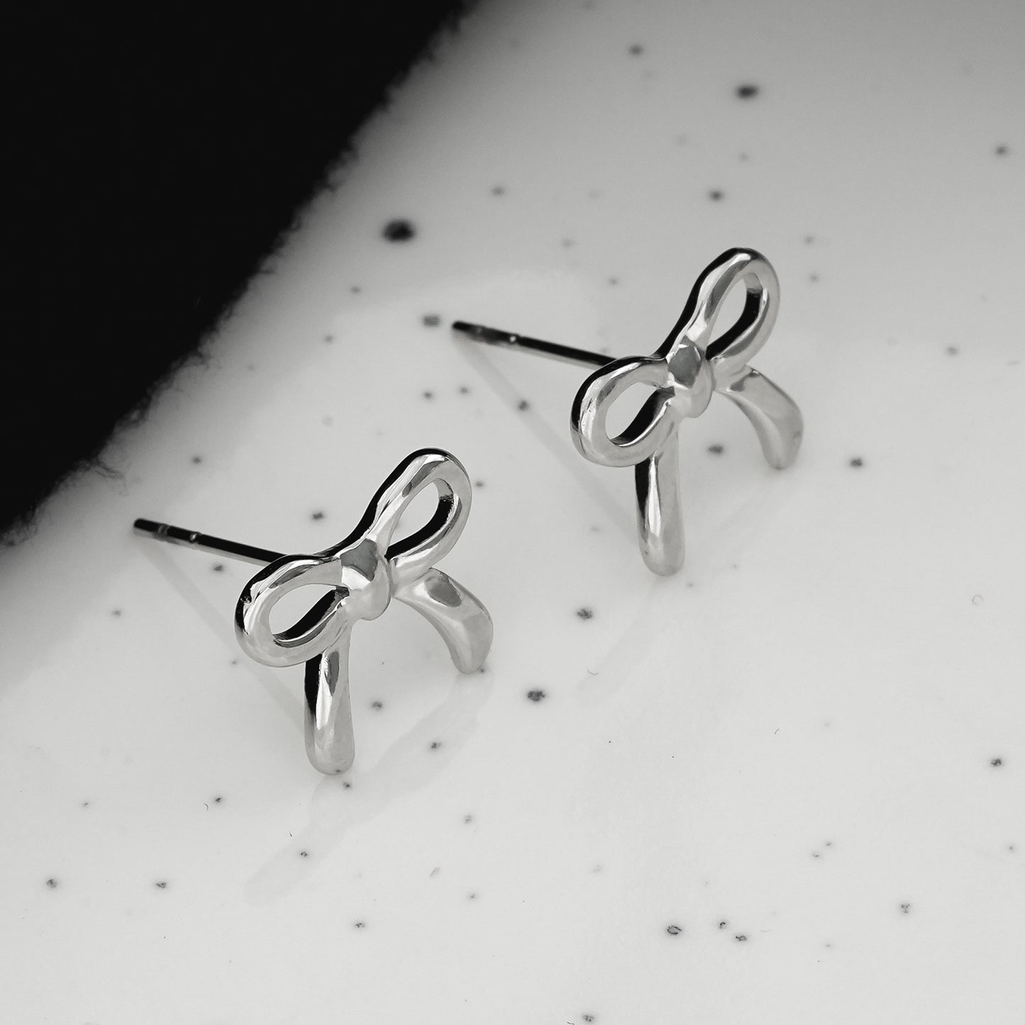 BOW: Silver Toned White Gold Bow Shaped Stud Earrings