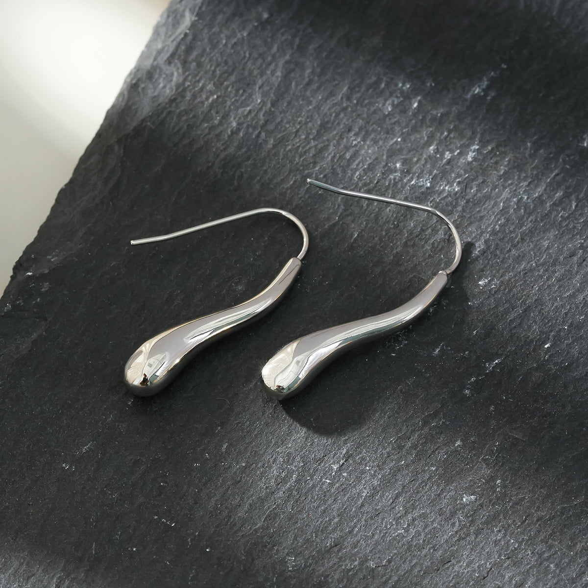 Style CORNING Silver Toned (White Gold): Tadpole-Shaped Earrings – Unique Elegance with a Playful Twist