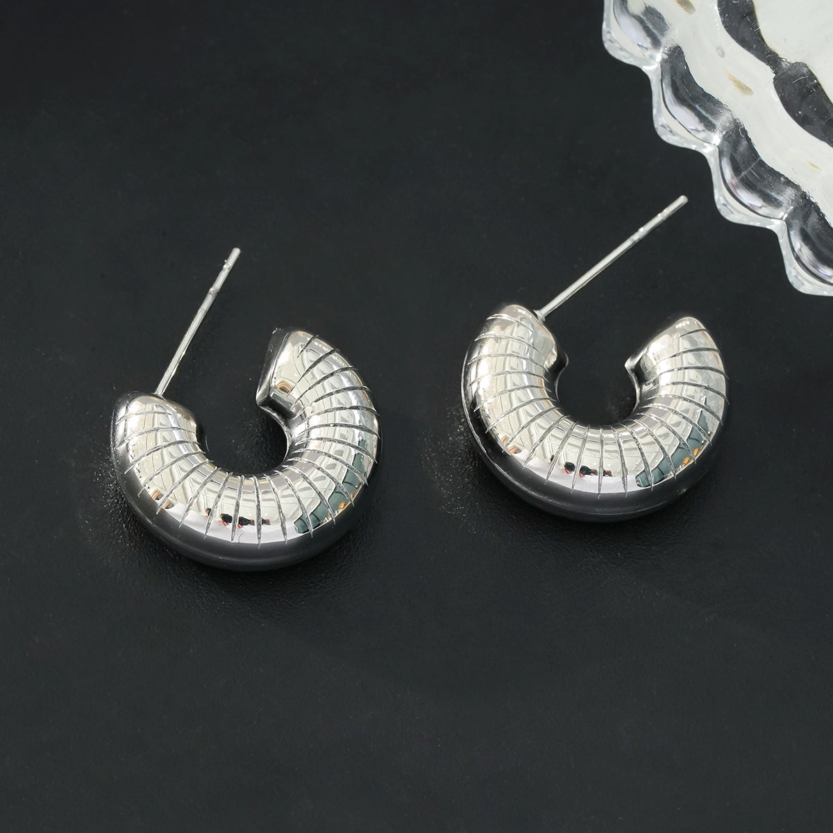 KOTOHIRA: Hollow Chunky-Look Textured Surface Tube Hoop Earrings in Silver Toned White Gold