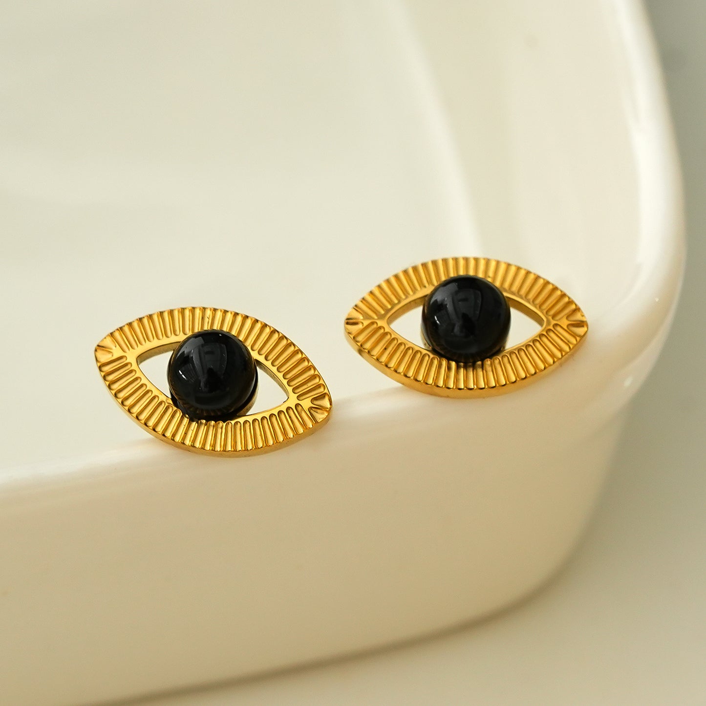 TAVIRA: Gold Evil Eye Studs with Black Onyx Embellishment